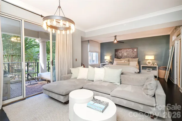 a living room with furniture and a chandelier