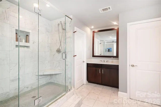 a spacious bathroom with a shower and a sink