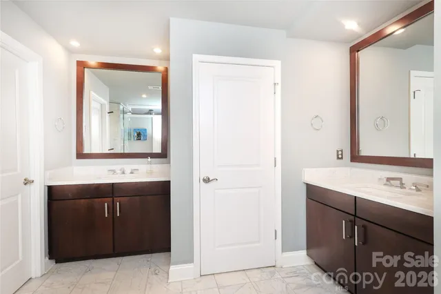 a bathroom with a sink vanity and mirror