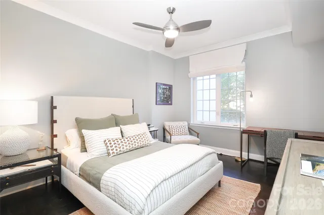 a bedroom with a bed and a desk with chair