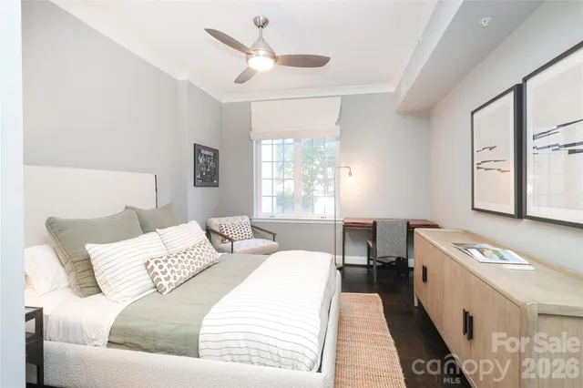 a bed room with a bed a couch and a window