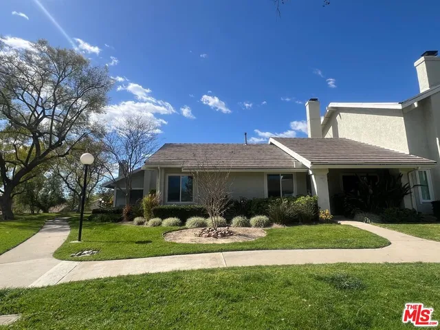 a front view of house with yard and outdoor seating