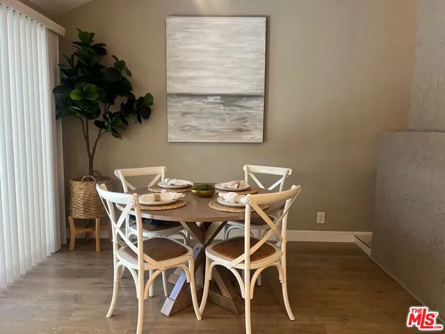 a view of a dining room with furniture and a potted plant