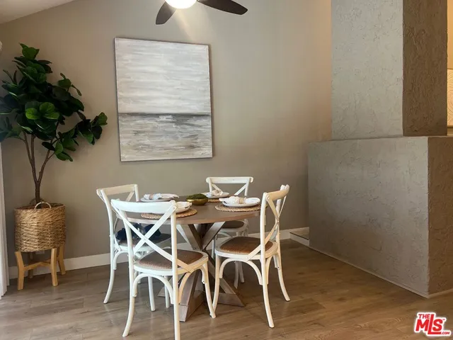 a view of a dining room with furniture and a potted plant