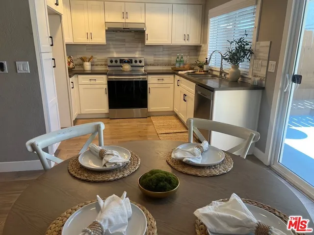 a kitchen with a table and chairs and stove