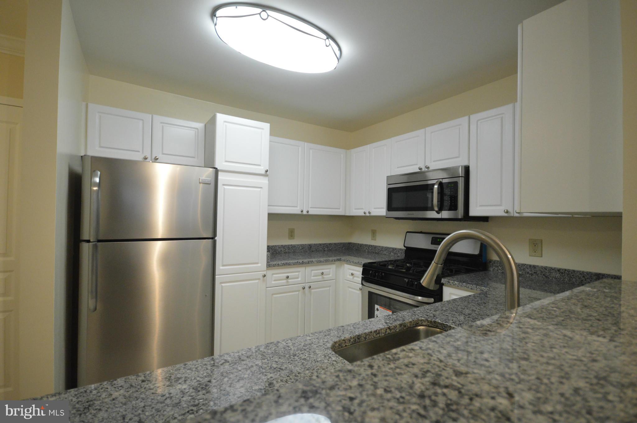 5575 Seminary Road, Unit 311 Falls Church, VA 22041 - Photo 23 of 30 a kitchen with stainless steel appliances granite countertop a refrigerator a stove a sink and a granite countertops