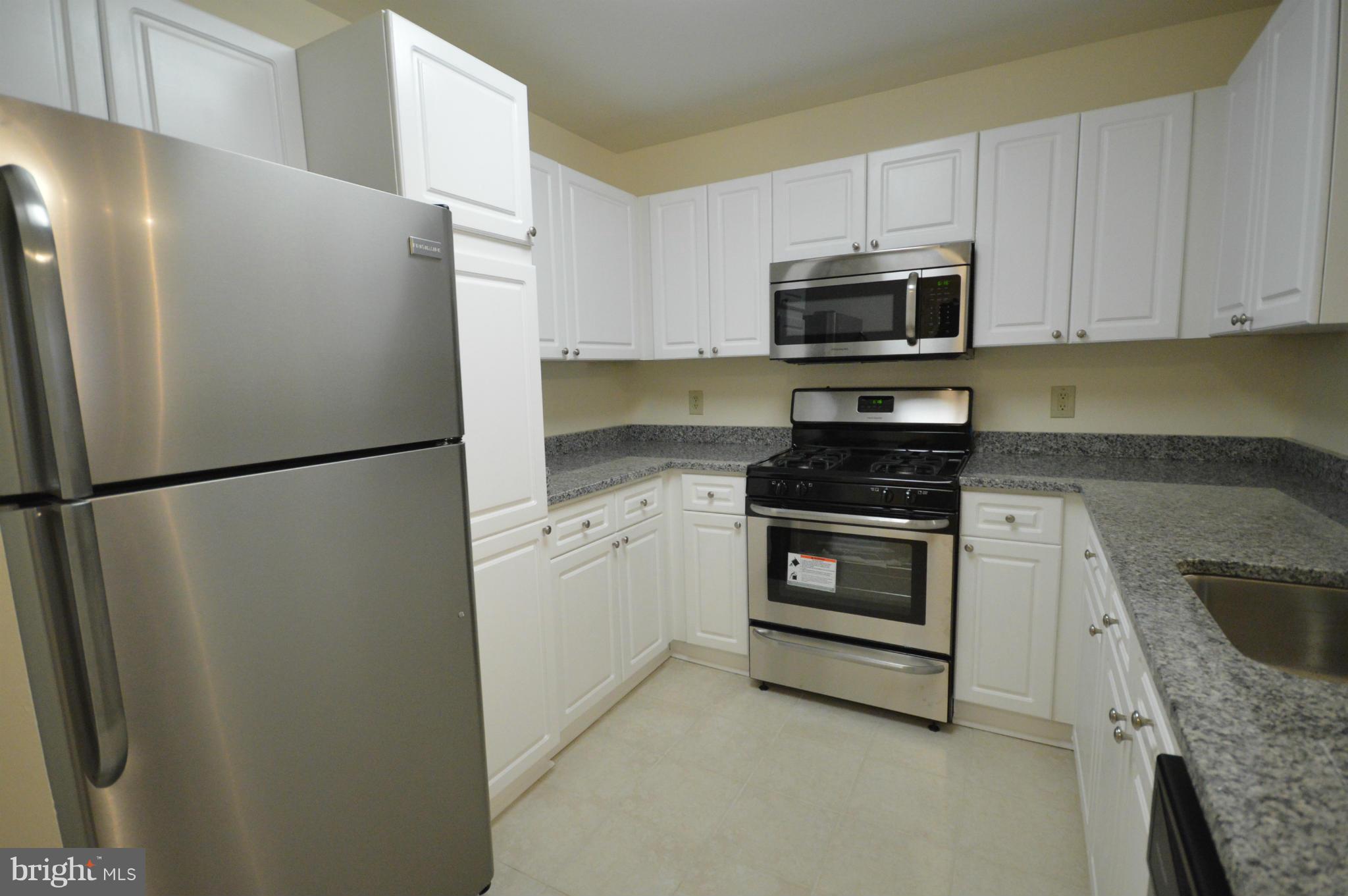 5575 Seminary Road, Unit 311 Falls Church, VA 22041 - Photo 24 of 30 a kitchen with stainless steel appliances a refrigerator stove and microwave