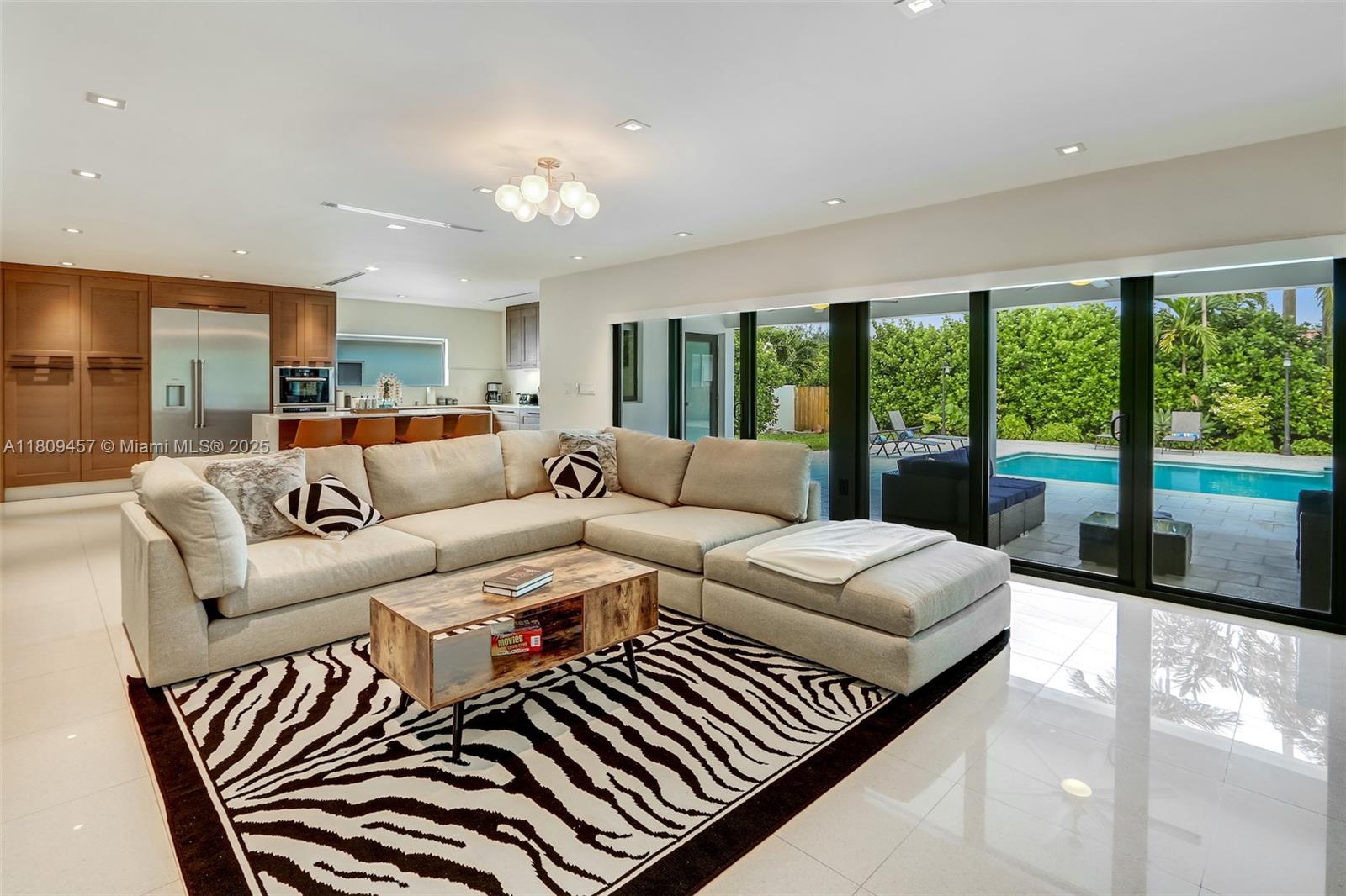 555 Southwest 27th Road Miami, FL 33129 - Photo 1 of 26 a living room with furniture and a large window