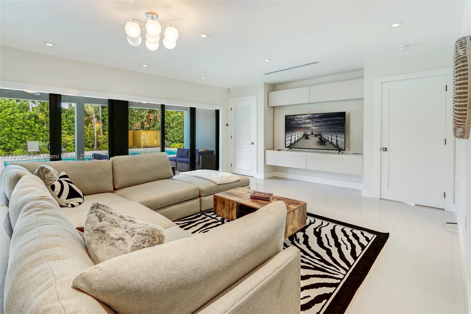 555 Southwest 27th Road Miami, FL 33129 - Photo 11 of 26 a living room with furniture and a large window