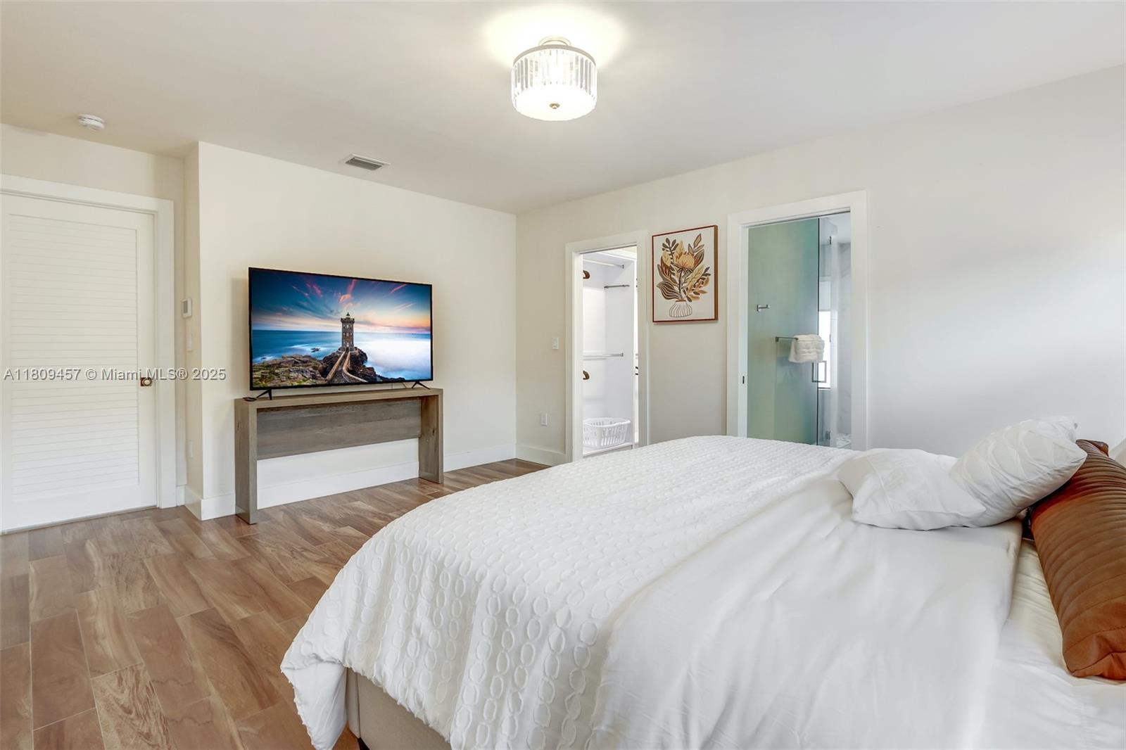 555 Southwest 27th Road Miami, FL 33129 - Photo 13 of 26 a bedroom with a bed and a flat screen tv