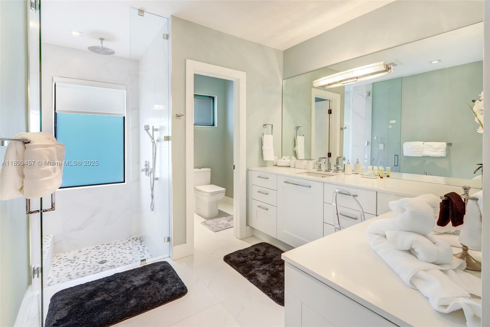 555 Southwest 27th Road Miami, FL 33129 - Photo 14 of 26 a bathroom with a sink a toilet and shower