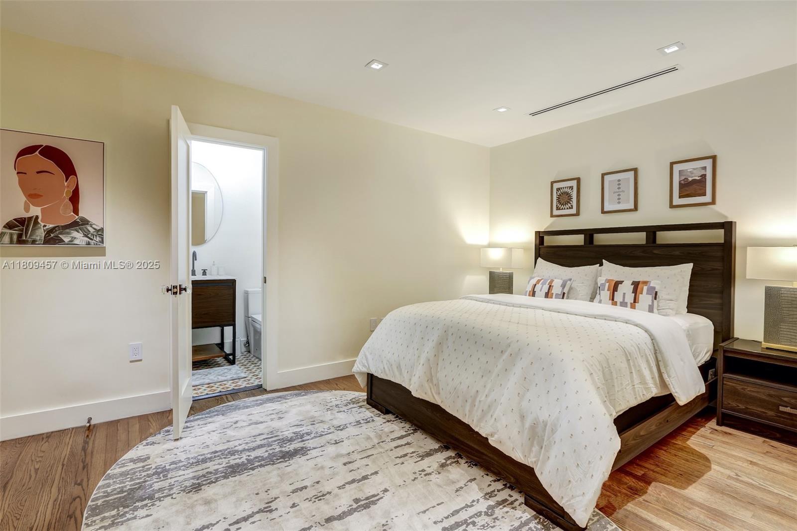 555 Southwest 27th Road Miami, FL 33129 - Photo 17 of 26 a bedroom with a bed and painting on the wall