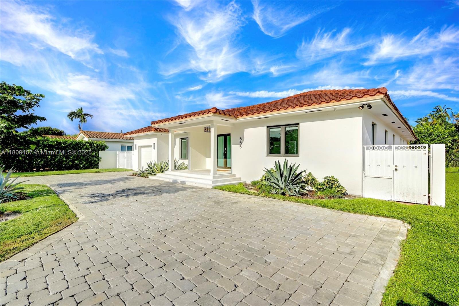 555 Southwest 27th Road Miami, FL 33129 - Photo 2 of 26 a front view of a house with a yard