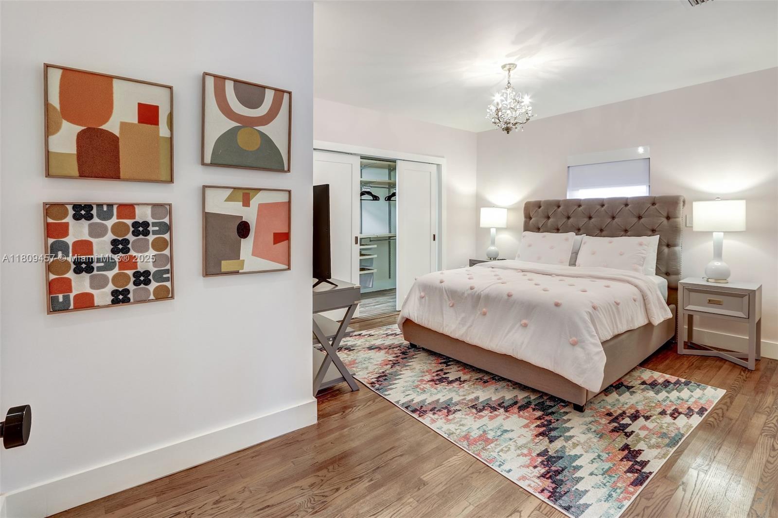 555 Southwest 27th Road Miami, FL 33129 - Photo 23 of 26 a bedroom with a bed and painting on the wall