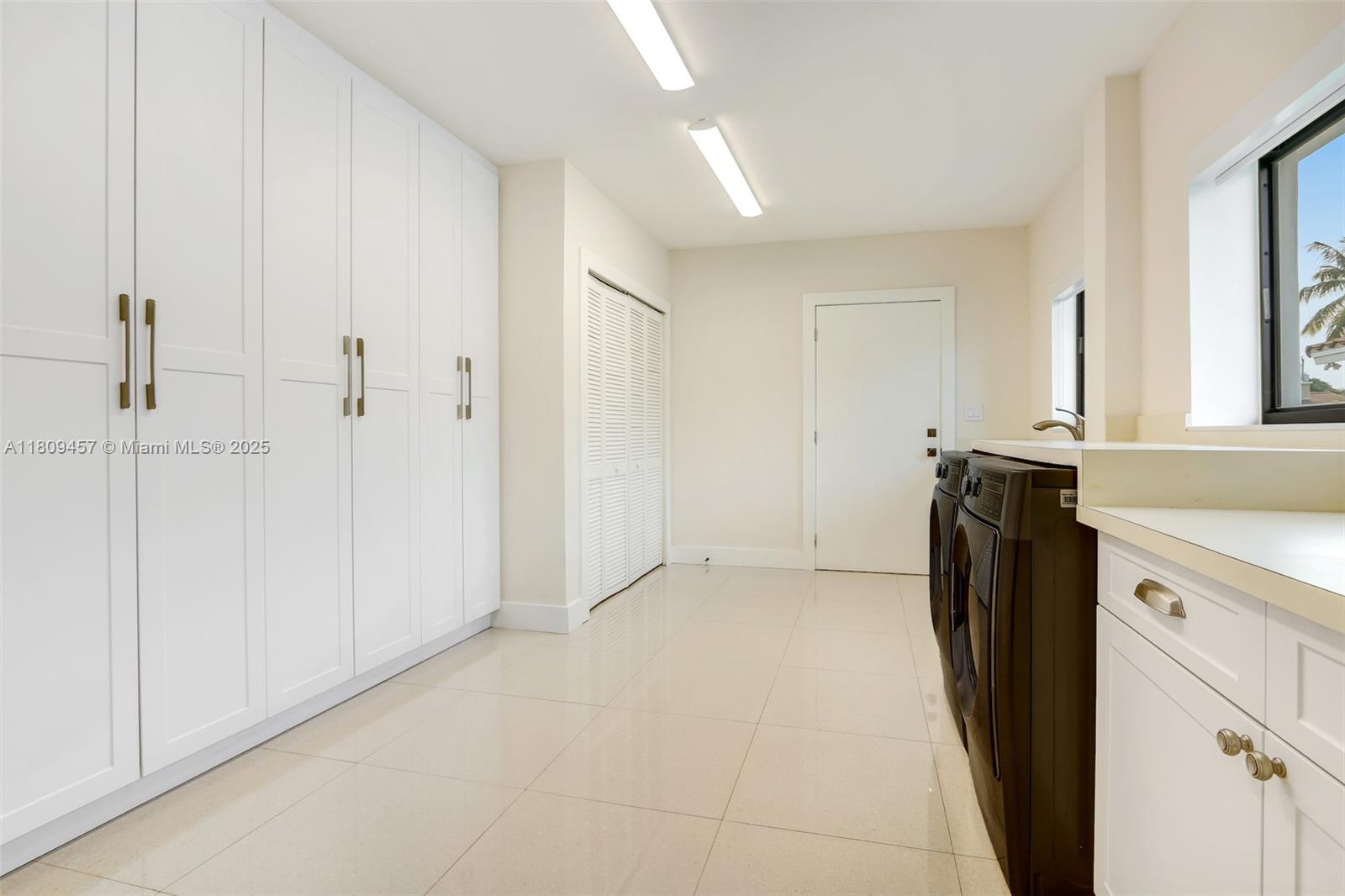 555 Southwest 27th Road Miami, FL 33129 - Photo 24 of 26 a view of a kitchen with refrigerator and white cabinets