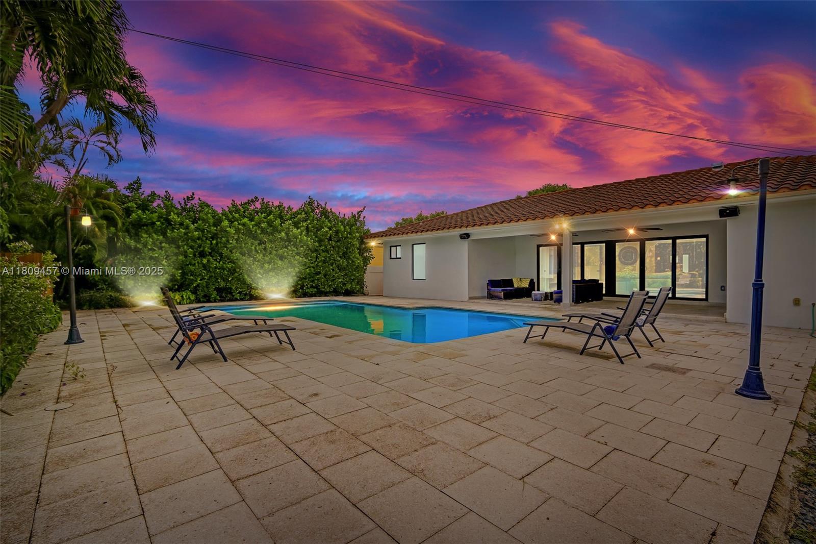 555 Southwest 27th Road Miami, FL 33129 - Photo 4 of 26 a view of a house with a bench in a backyard