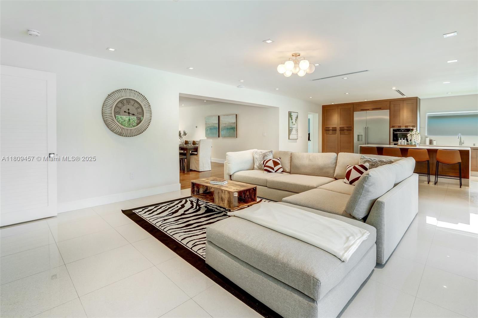 555 Southwest 27th Road Miami, FL 33129 - Photo 8 of 26 a living room with furniture and a chandelier