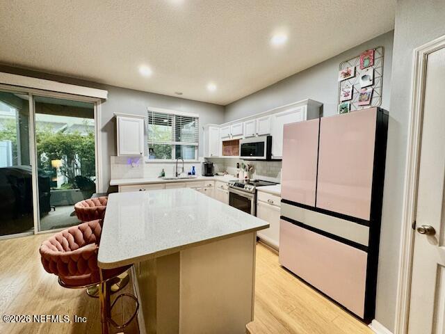 8852 Inlet Bluff Drive Jacksonville, FL 32216 - Photo 19 of 53 a kitchen with stainless steel appliances a stove a refrigerator sink a stove and white cabinets