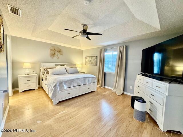 8852 Inlet Bluff Drive Jacksonville, FL 32216 - Photo 23 of 53 a bedroom with a bed and a flat screen tv