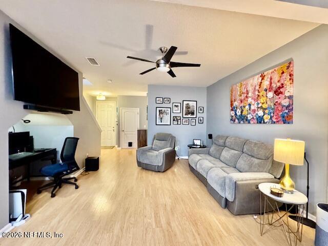 8852 Inlet Bluff Drive Jacksonville, FL 32216 - Photo 9 of 53 a living room with furniture and a flat screen tv