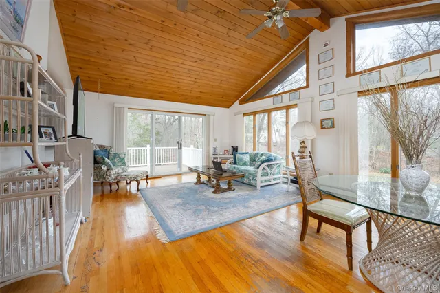 a living room with furniture a wooden floor and a large window