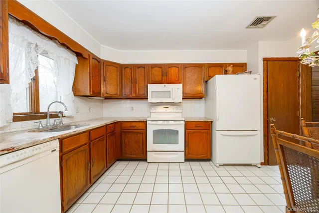a kitchen with a refrigerator sink and stove