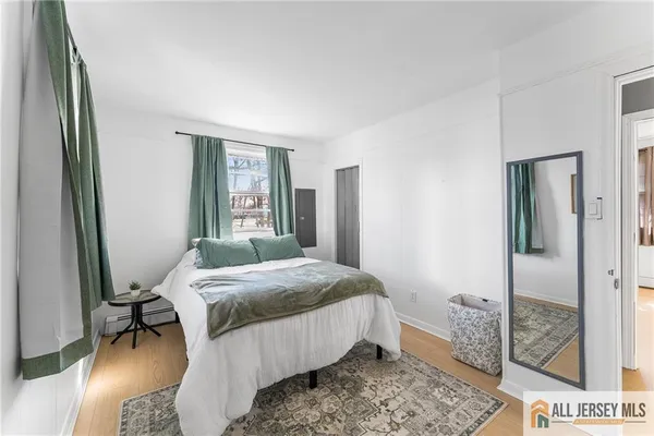 a bedroom with a bed and a mirror