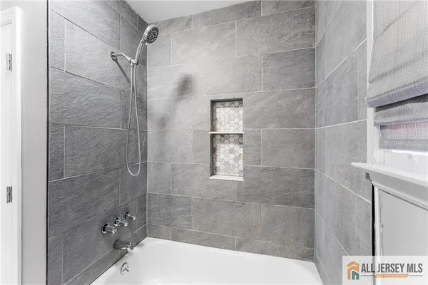 a bathroom with a bathtub and shower