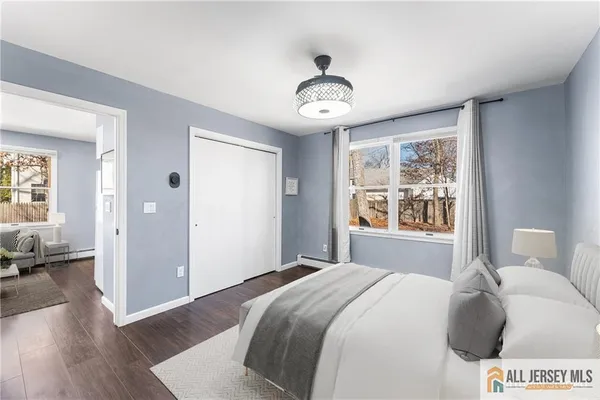 a bedroom with a large bed and a window