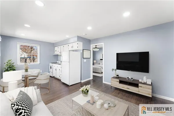 a living room with furniture and a flat screen tv