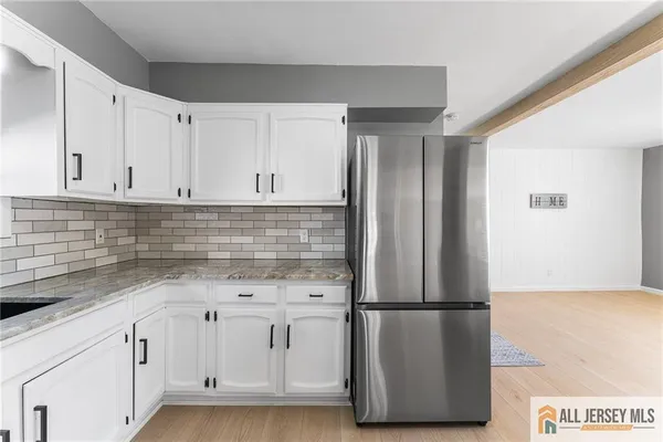 a view of a refrigerator with cabinets