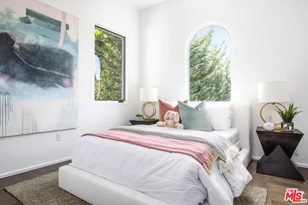 a bedroom with bed and a window