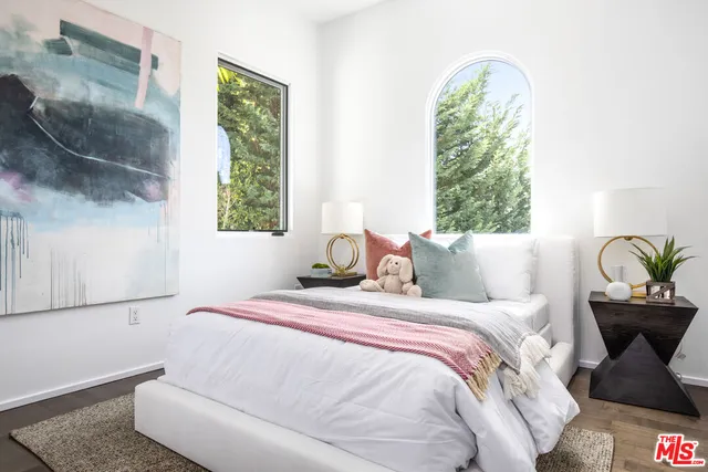 a bedroom with bed and a window