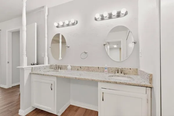 a view of a room with wooden floor and ceiling fan