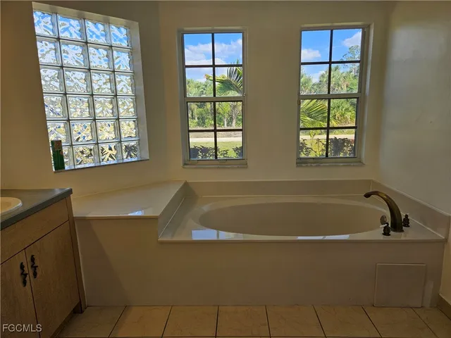 a bath tub sitting next to a window