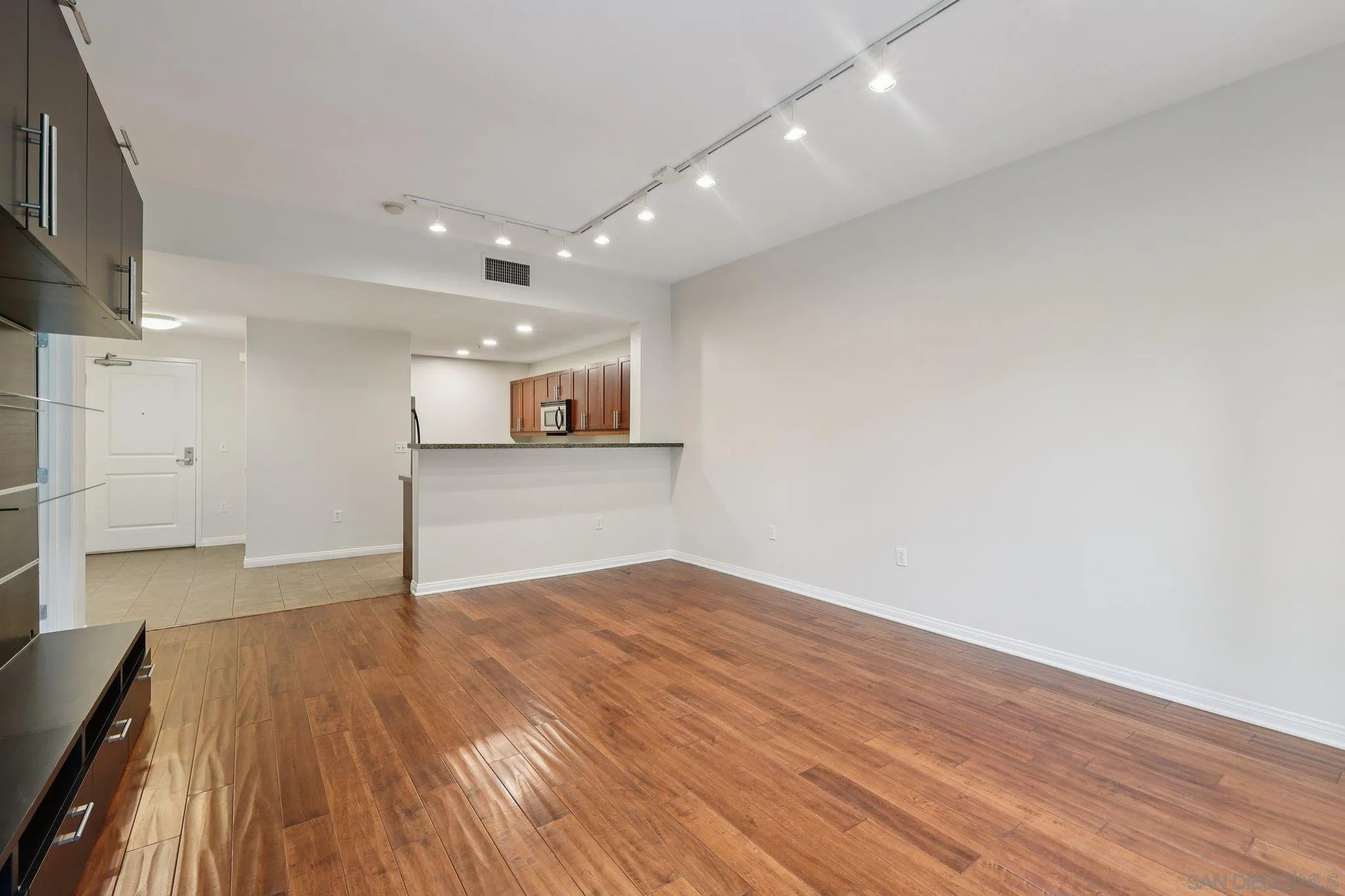 206 Park Boulevard, Unit 307 San Diego, CA 92101 - Photo 10 of 42 a view of an empty room with wooden floor