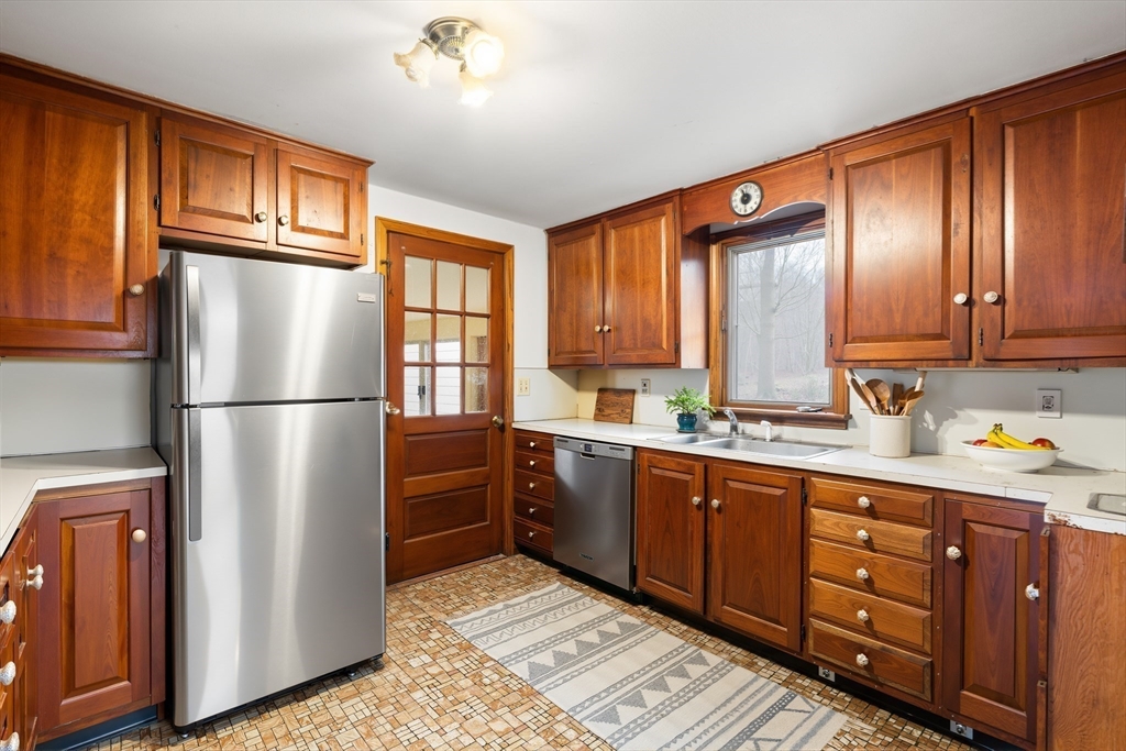 154 Birch Street Braintree, MA 02184 - Photo 12 of 38 a kitchen with stainless steel appliances granite countertop a refrigerator sink and cabinets