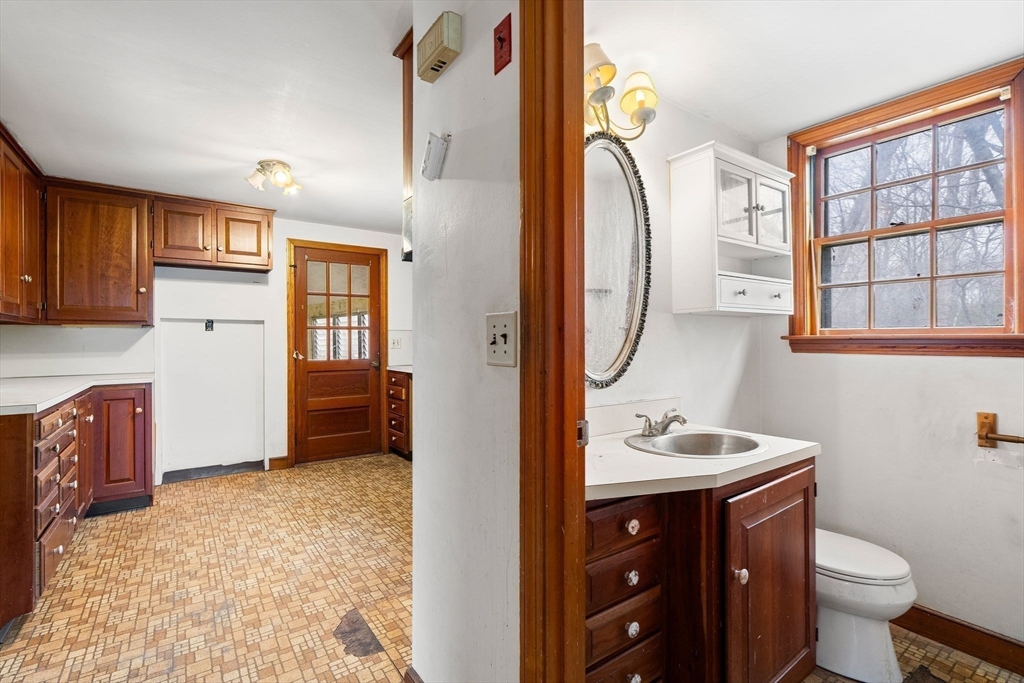 154 Birch Street Braintree, MA 02184 - Photo 15 of 38 a bathroom with a sink a toilet and a mirror