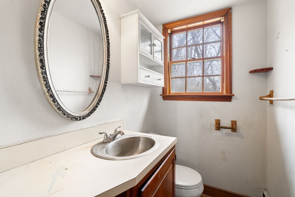 154 Birch Street Braintree, MA 02184 - Photo 16 of 38 a bathroom with a sink a toilet and a mirror