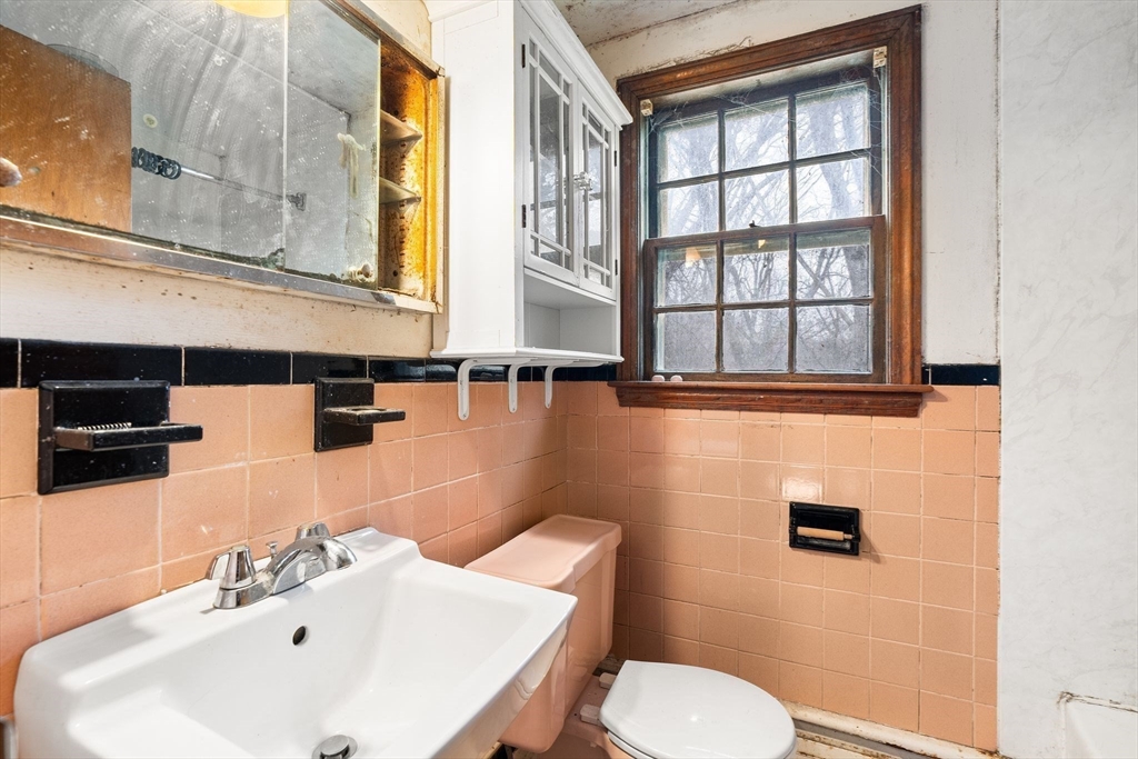 154 Birch Street Braintree, MA 02184 - Photo 25 of 38 a bathroom with a sink and a toilet