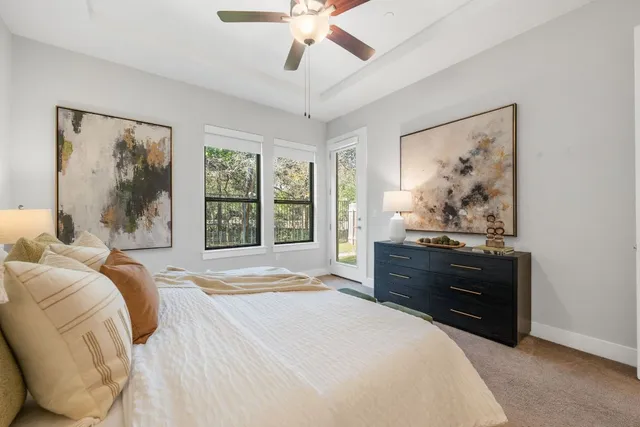 a bedroom with a bed dresser and window