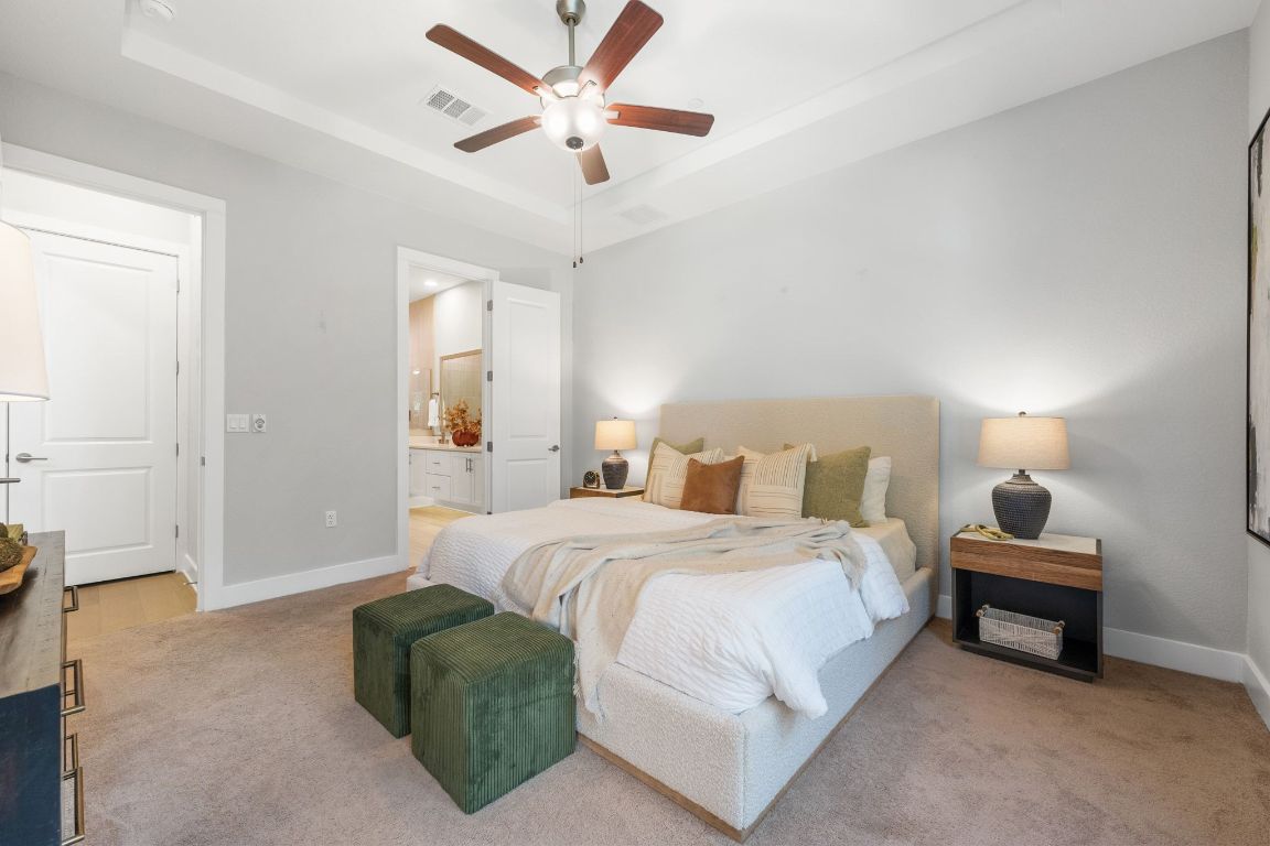 4323 Spicewood Springs Road, Unit 9 Austin, TX 78759 - Photo 18 of 31 Bedroom with a raised ceiling, ceiling fan, connected bathroom, and carpet