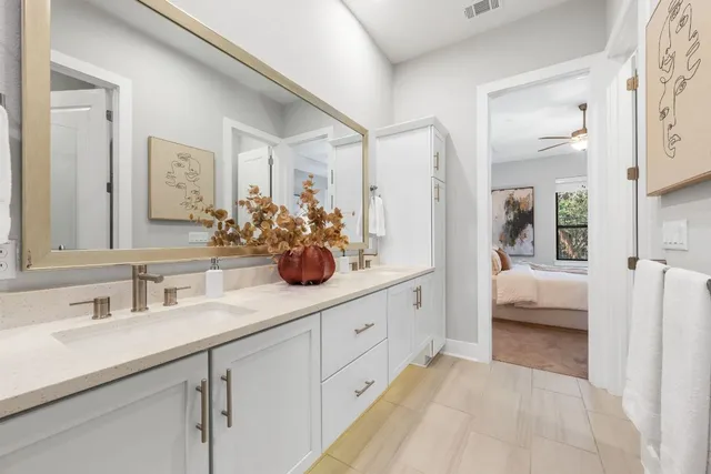 a en suite bathroom with double sink and a mirror