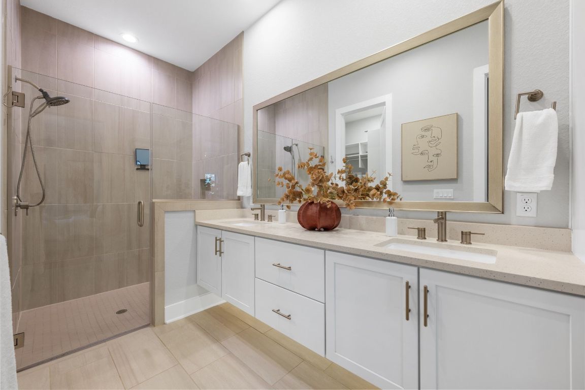 4323 Spicewood Springs Road, Unit 9 Austin, TX 78759 - Photo 20 of 31 Primary bathroom featuring double vanity, walk-in shower