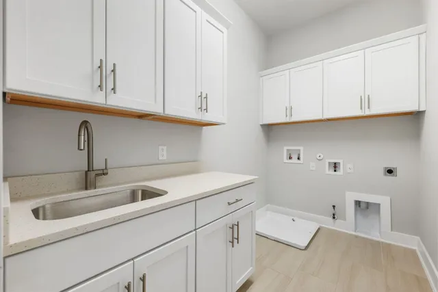 a kitchen with white cabinets and a sink
