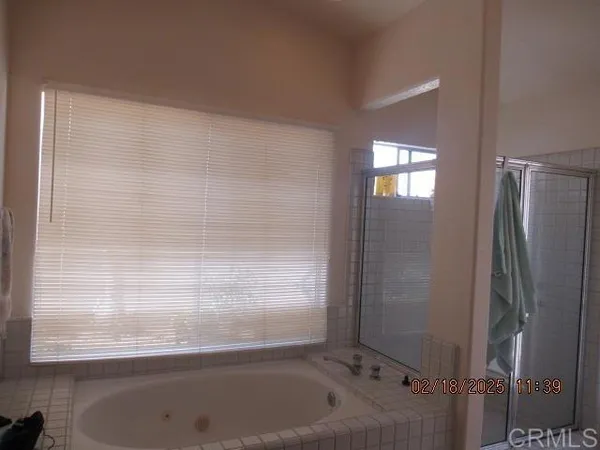 a bathroom with a granite countertop sink a light fixture and a mirror