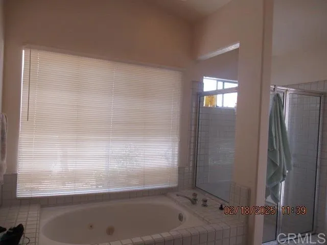 a bathroom with a granite countertop sink a light fixture and a mirror