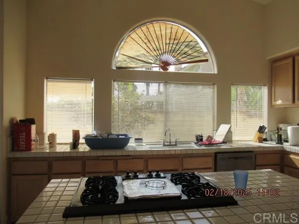 a kitchen with a sink stove and cabinets