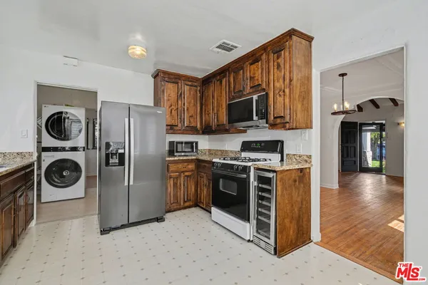 a kitchen with stainless steel appliances granite countertop a stove a refrigerator and a microwave
