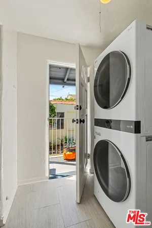 a view of a hallway with washer and dryer